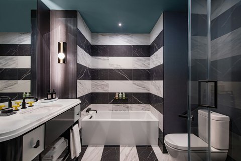 Guest Bathroom with Bathtub in some Studio Suites