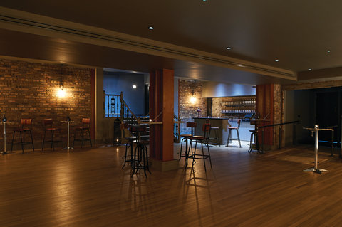 Our industrial-style cellar is a unique venue with a bar and stage