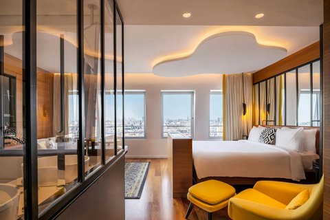 King size bed, yellow chair , XXL windows