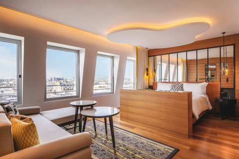 Sofa, table, king size bed, XXL windows Paris view