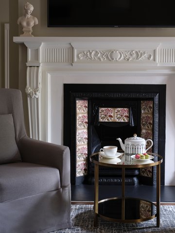Take a seat by the fireplace and enjoy a moment of relaxation.