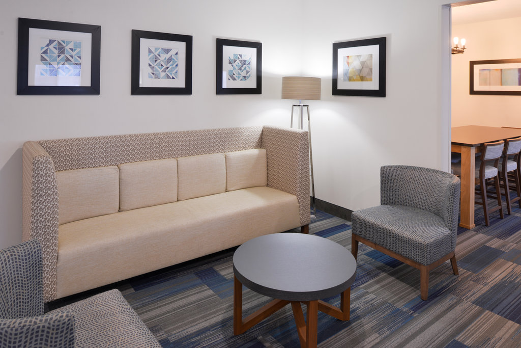 Relax in Hotel Lobby featuring sofas & chairs and two televisions