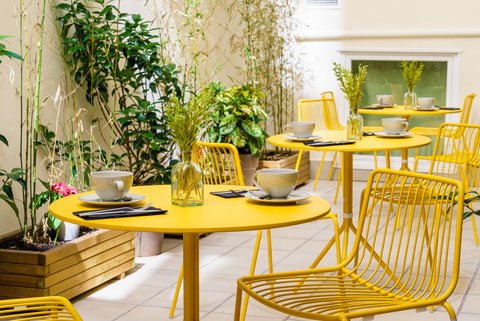 Coffee On Yellow Tables In Patio
