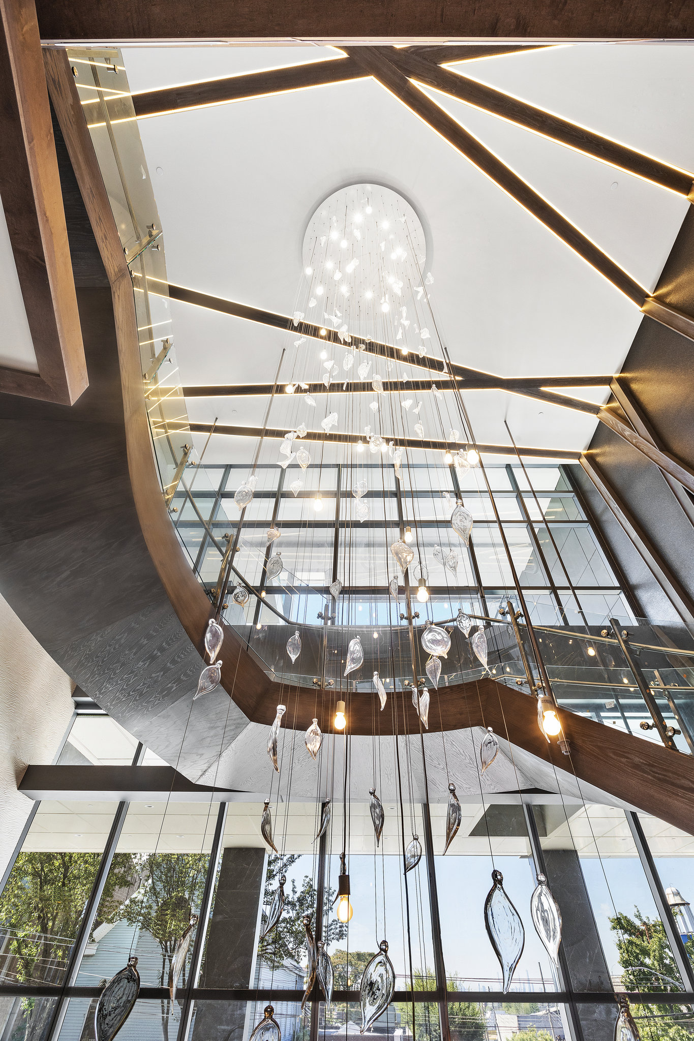 Cascading Crystal Leaves Chandelier Surrounds Floating Staircase