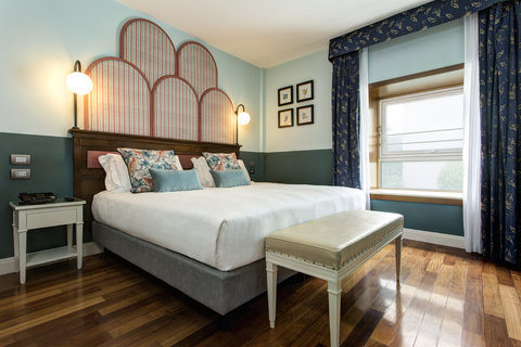 35sqm and well-lit Suite with plush king size bed and living area.