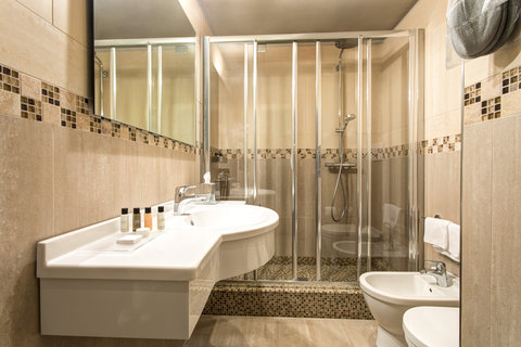 Spacious Premium Rooms bathroom with luxury toiletry set.