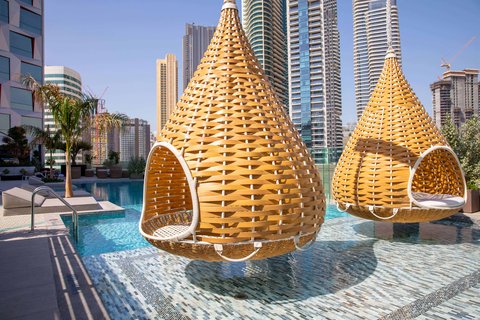 Hanging pods by the outdoor pool at Hotel Indigo Dubai Downtown