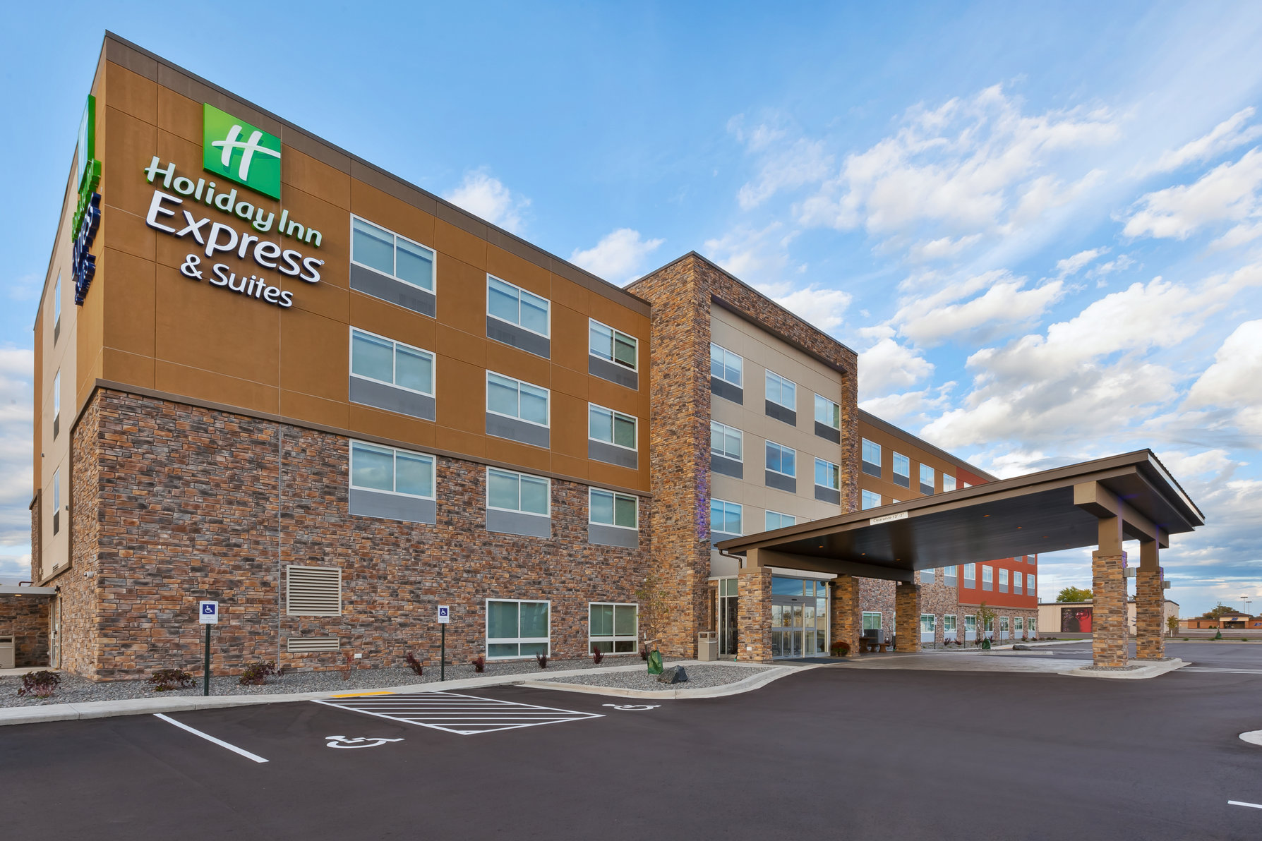 Hotel Exterior with Well Lit Parking Lot 