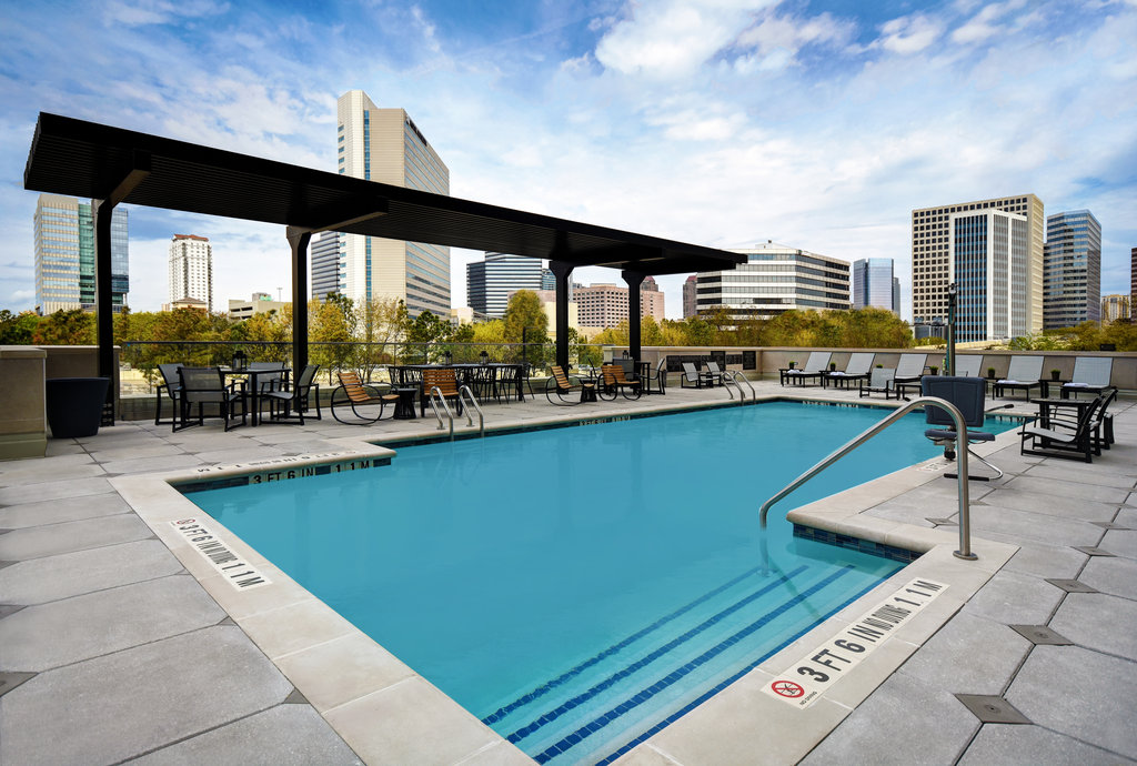 Outdoor heated pool with skyline view of the Galleria area
