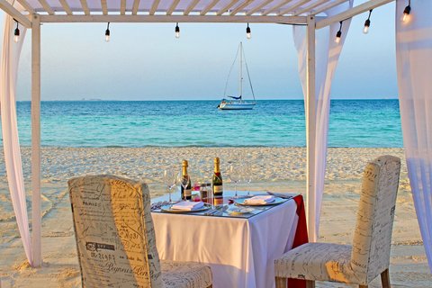 Have a romantic dinner by the sea.