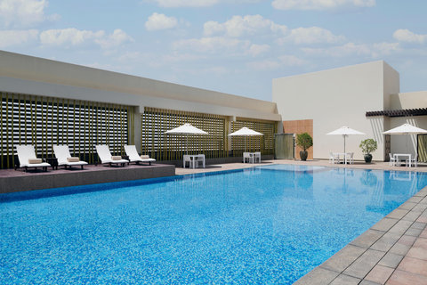 Spa floor lap pool with relaxing sun beds & a bar by the pool