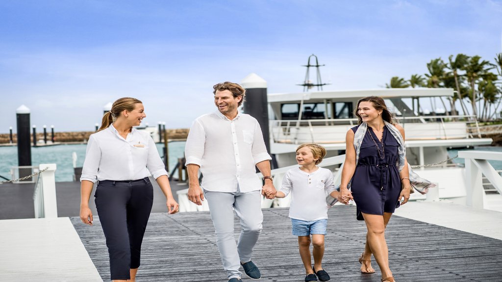 Concierge meeting guests on arrival at resort marina 
