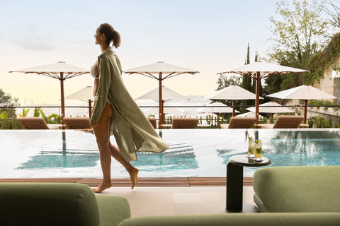 METT Barcelona Hotel Pool Club Outdoor Pool Woman Walking Barcelona Skyline